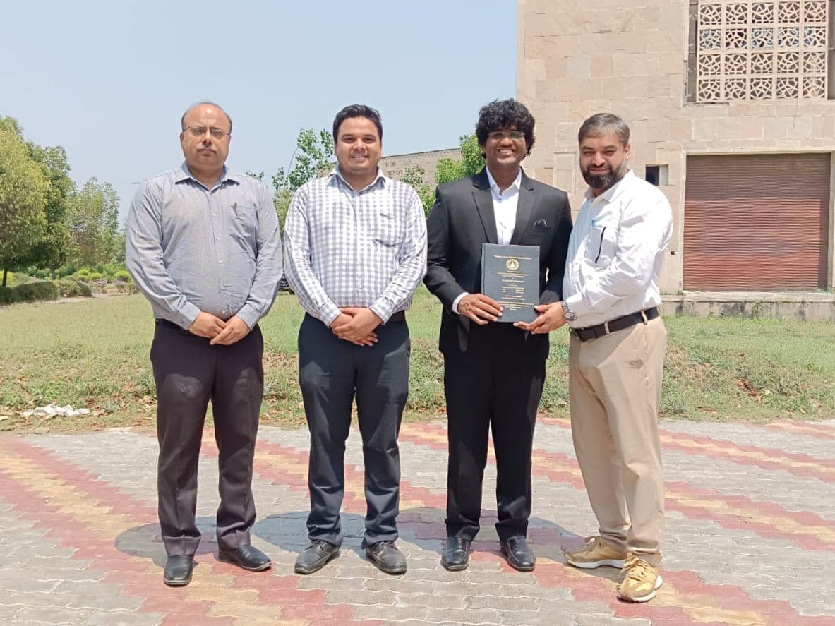 Siddharth Kumar with faculty and the Dean at Gautam Buddha University following the final-year project presentation, holding the bound project report.